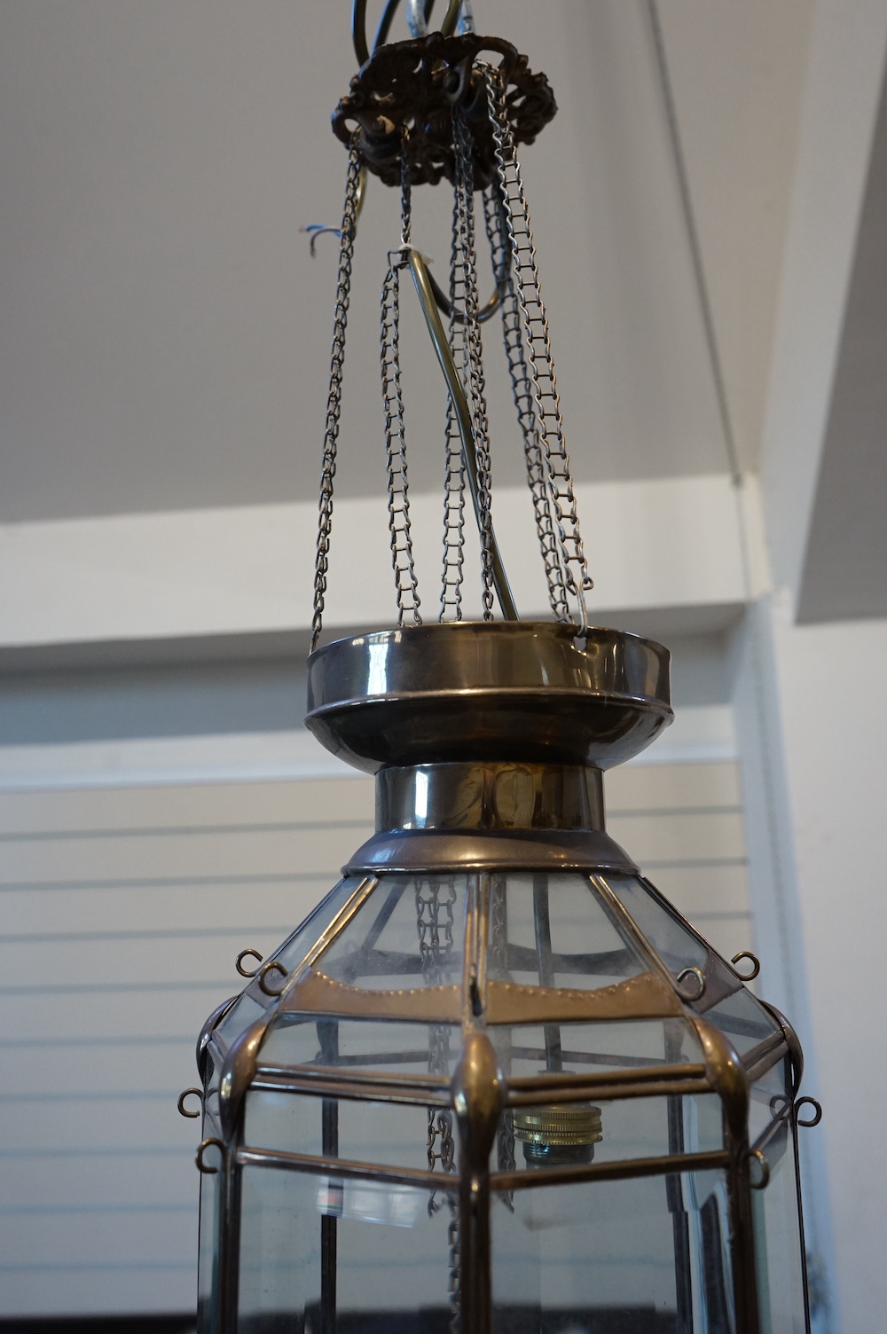 A Moroccan hanging brass and eight panelled glass lantern, 60cm long. Condition - good